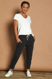 Model Katie wearing size 10 of the Fundamental Brunch Cotton Pant in colour Navy (Blue), from the front, showing the whole outfit