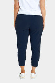 Model Laura wearing size 14 of the Fundamental Brunch Cotton Pant in colour Navy (Blue), from the back
