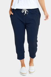 Model Laura wearing size 14 of the Fundamental Brunch Cotton Pant in colour Navy (Blue), from the front, cropped image