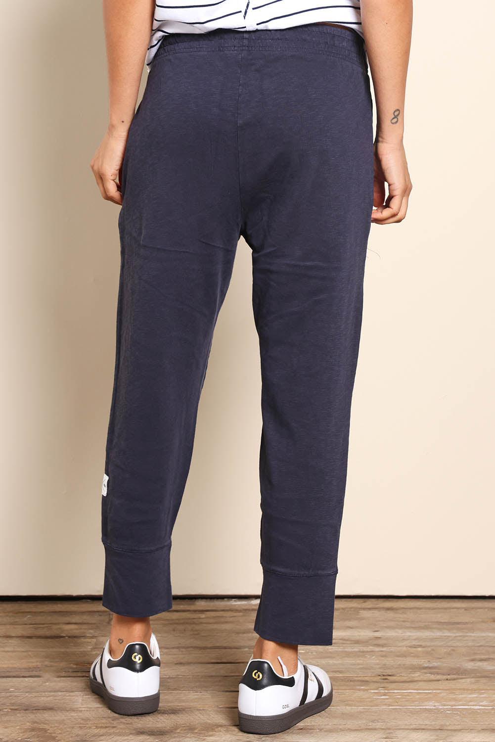 Model Pamelar wearing size 10 of the Fundamental Brunch Cotton Pant - Navy in colour Navy, from the back