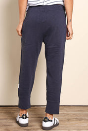 Model Pamelar wearing size 10 of the Fundamental Brunch Cotton Pant - Navy in colour Navy, from the back
