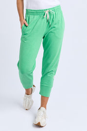 A model wearing the Fundamental Brunch Cotton Pant in colour Springgree (Green), from the front, cropped image