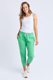 A model wearing the Fundamental Brunch Cotton Pant in colour Springgree (Green), from the front, showing the whole outfit