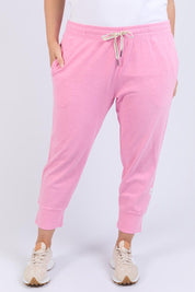 A model wearing the Fundamental Brunch Cotton Pant in colour Strawberry (Pink), from the front, cropped image
