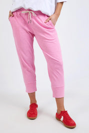 A model wearing the Fundamental Brunch Cotton Pant in colour Strawberry (Pink), from the front, cropped image