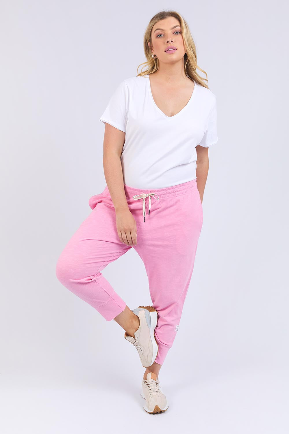 A model wearing the Fundamental Brunch Cotton Pant in colour Strawberry (Pink), from the front, showing the whole outfit