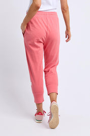 A model wearing the Fundamental Brunch Cotton Pant in colour Sugarcoral (Pink), from the back