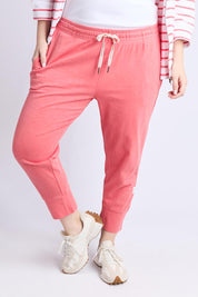 A model wearing the Fundamental Brunch Cotton Pant in colour Sugarcoral (Pink), from the front, cropped image