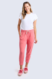 A model wearing the Fundamental Brunch Cotton Pant in colour Sugarcoral (Pink), from the front, showing the whole outfit