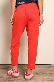 Model Pamelar wearing size 10 of the Fundamental Brunch Cotton Pant – Tangello in colour Tangello, from the back