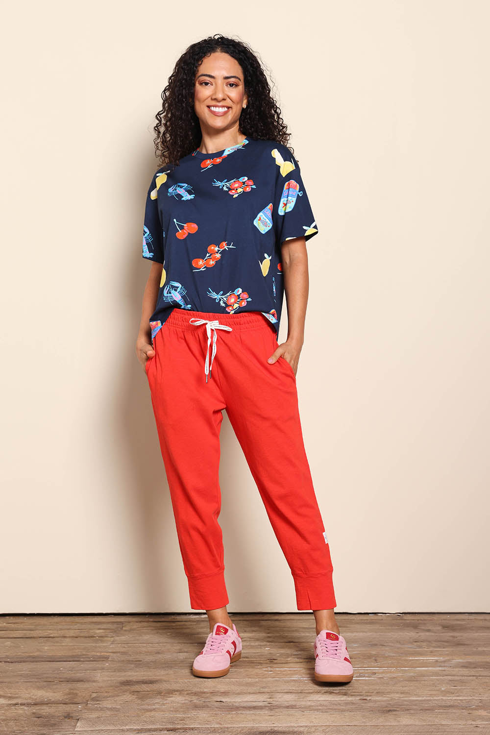 Model Pamelar wearing size 10 of the Fundamental Brunch Cotton Pant – Tangello in colour Tangello, from the front