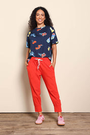 Model Pamelar wearing size 10 of the Fundamental Brunch Cotton Pant – Tangello in colour Tangello, from the front