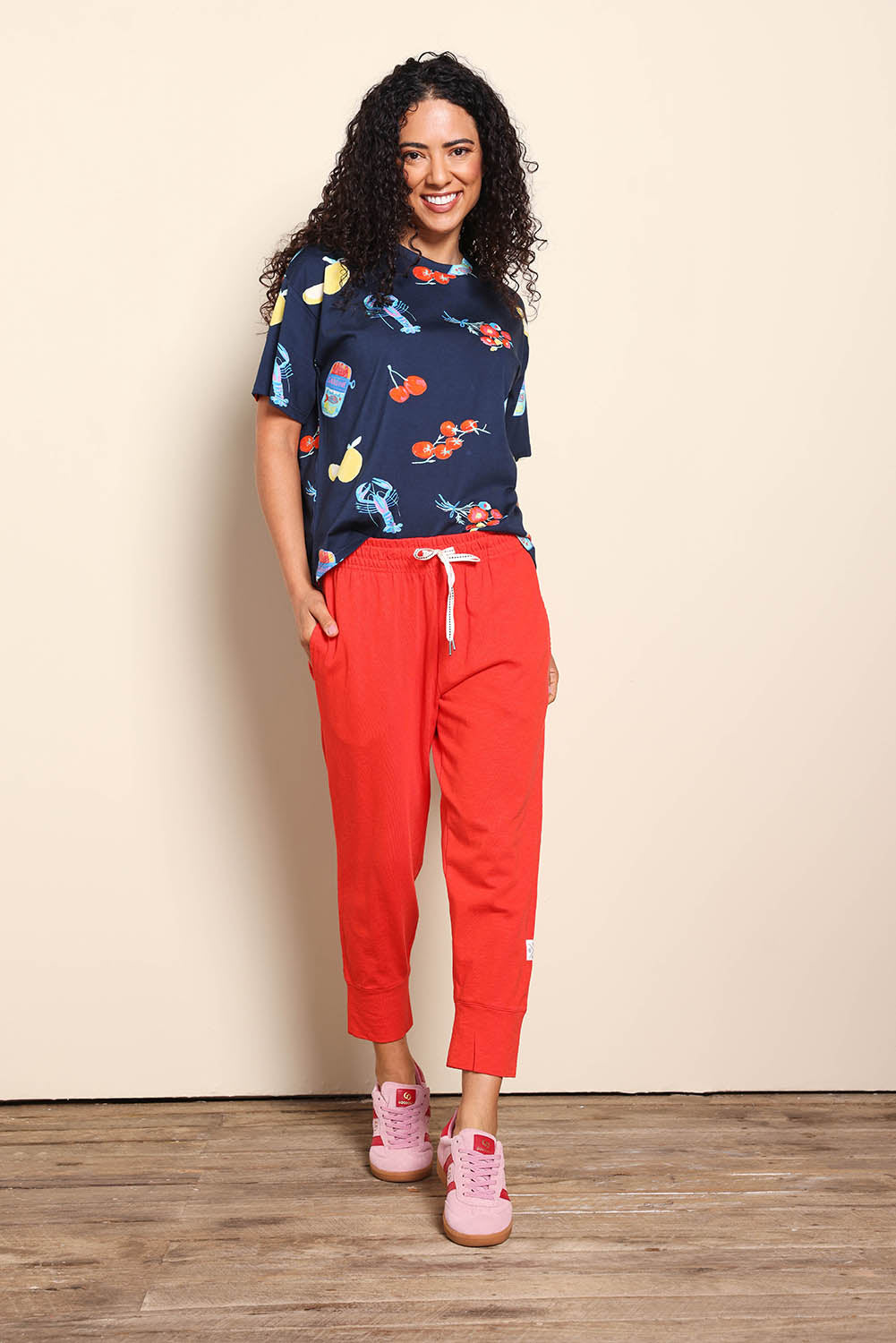 Model Pamelar wearing size 10 of the Fundamental Brunch Cotton Pant – Tangello in colour Tangello, from the front