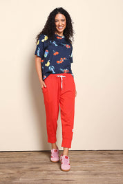 Model Pamelar wearing size 10 of the Fundamental Brunch Cotton Pant – Tangello in colour Tangello, from the front