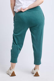 A model wearing the Fundamental Brunch Cotton Pant in colour Teal (Green), from the back
