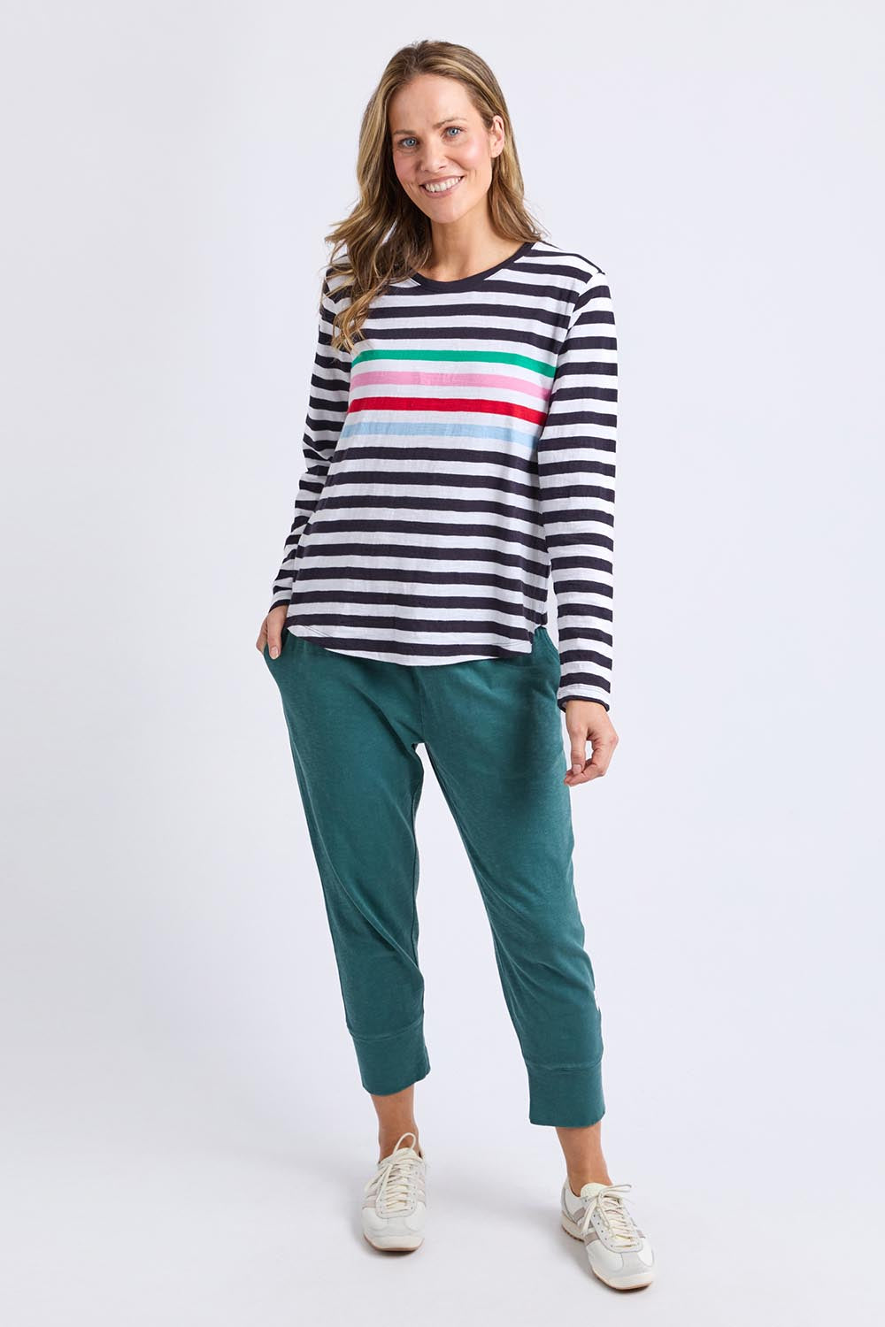 A model wearing the Fundamental Brunch Cotton Pant in colour Teal (Green), from the front, showing the whole outfit