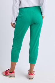 A model wearing the Fundamental Brunch Cotton Pant in colour Turquoise (Green), from the back