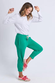A model wearing the Fundamental Brunch Cotton Pant in colour Turquoise (Green), from the front, showing the whole outfit