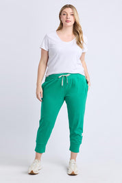 A model wearing the Fundamental Brunch Cotton Pant in colour Turquoise (Green), from the front, showing the whole outfit