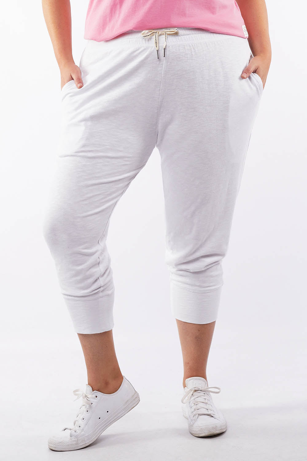 A model wearing the Fundamental Brunch Cotton Pant in colour White (White), from the front, cropped image