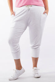 A model wearing the Fundamental Brunch Cotton Pant in colour White (White), from the front, cropped image
