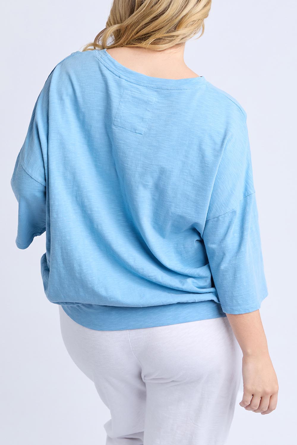 A model wearing the Fundamental Mazie Cotton Sweat Top in colour Duskblue (Blue), from the back