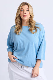 A model wearing the Fundamental Mazie Cotton Sweat Top in colour Duskblue (Blue), from the front, cropped image