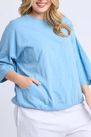 A model wearing the Fundamental Mazie Cotton Sweat Top in colour Duskblue (Blue), from the front, cropped image