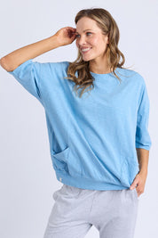 A model wearing the Fundamental Mazie Cotton Sweat Top in colour Duskblue (Blue), from the front, cropped image