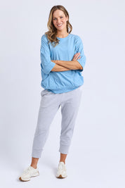 A model wearing the Fundamental Mazie Cotton Sweat Top in colour Duskblue (Blue), from the front, showing the whole outfit