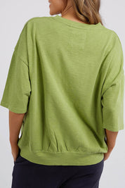 A model wearing the Fundamental Mazie Cotton Sweat Top in colour Junglegre (Green), from the back