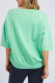 A model wearing the Fundamental Mazie Cotton Sweat Top in colour Meadow (Green), from the back