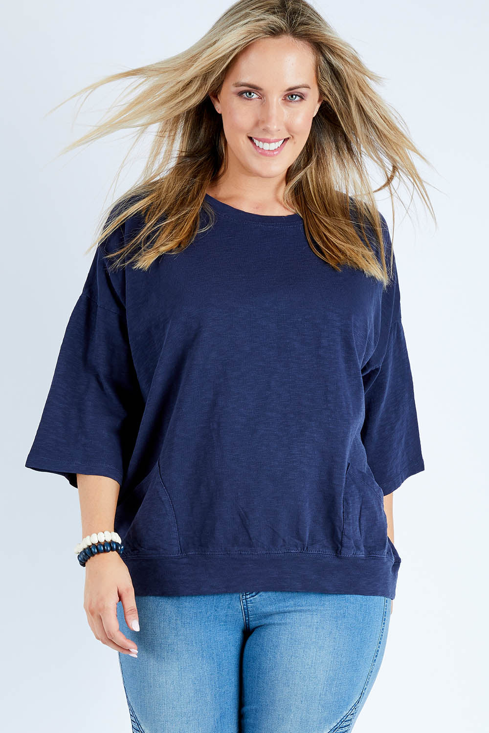 Model Jess wearing size 14 of the Fundamental Mazie Cotton Sweat Top in colour Navy (Blue), from the front, cropped image