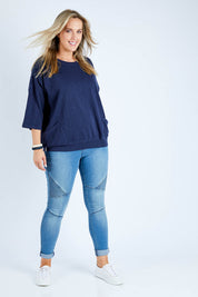 Model Jess wearing size 14 of the Fundamental Mazie Cotton Sweat Top in colour Navy (Blue), from the front, showing the whole outfit