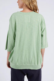 A model wearing the Fundamental Mazie Cotton Sweat Top in colour Quietgreen (Green), from the back