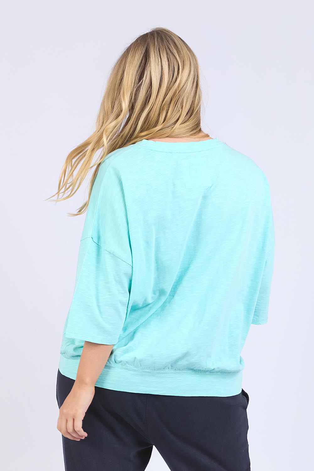 A model wearing the Fundamental Mazie Cotton Sweat Top in colour Tonicblue (Blue), from the back