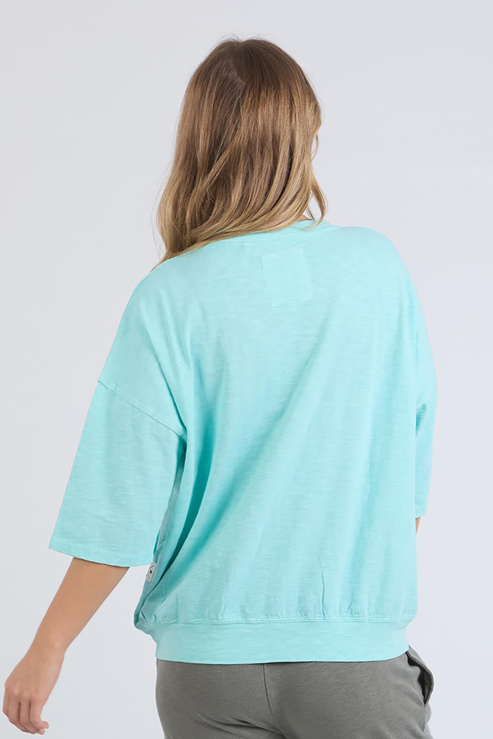 A model wearing the Fundamental Mazie Cotton Sweat Top in colour Tonicblue (Blue), from the back