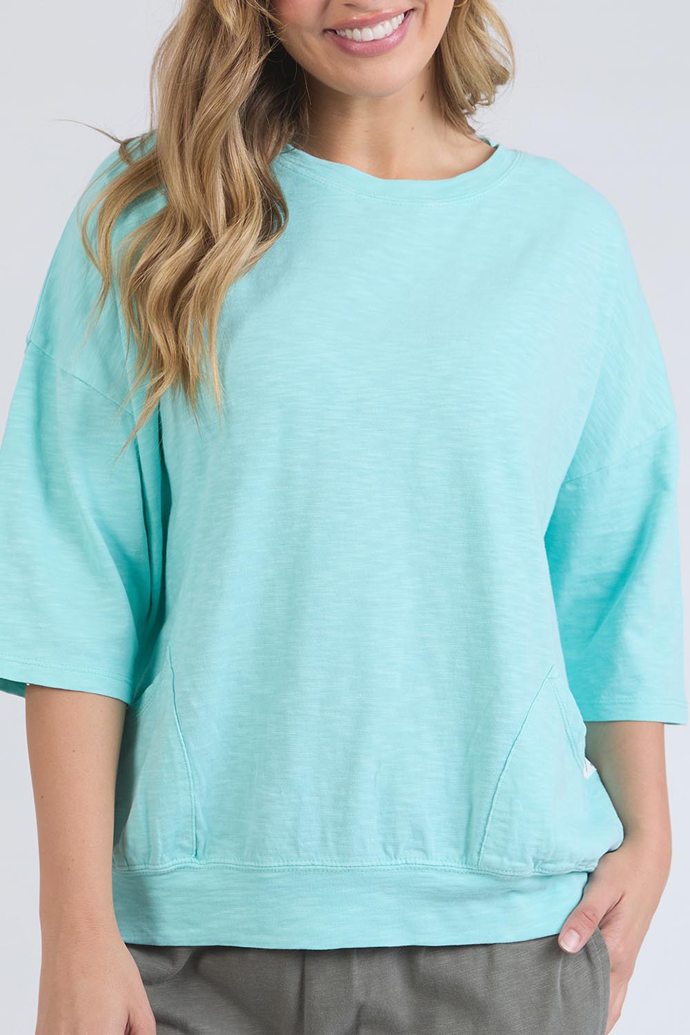 A model wearing the Fundamental Mazie Cotton Sweat Top in colour Tonicblue (Blue), from the front, cropped image