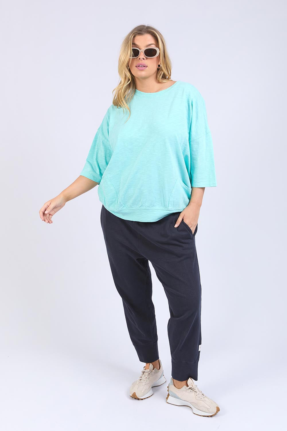 A model wearing the Fundamental Mazie Cotton Sweat Top in colour Tonicblue (Blue), from the front, showing the whole outfit
