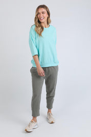 A model wearing the Fundamental Mazie Cotton Sweat Top in colour Tonicblue (Blue), from the front, showing the whole outfit