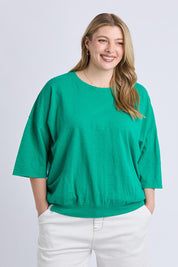 A model wearing the Fundamental Mazie Cotton Sweat Top in colour Turquoise (Green), from the front, cropped image