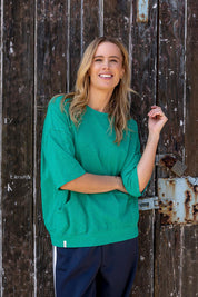 A model wearing the Fundamental Mazie Cotton Sweat Top in colour Turquoise (Green), from the front, showing the whole outfit