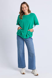 A model wearing the Fundamental Mazie Cotton Sweat Top in colour Turquoise (Green), from the front, showing the whole outfit
