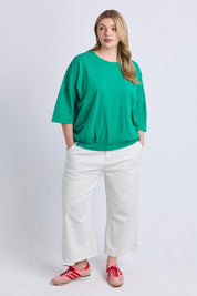 A model wearing the Fundamental Mazie Cotton Sweat Top in colour Turquoise (Green), from the front, showing the whole outfit