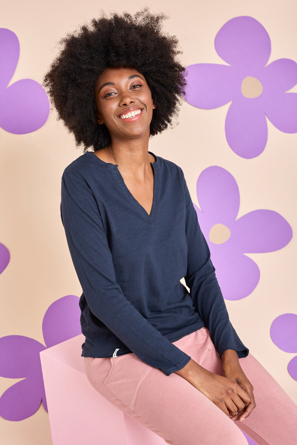 Model Aiyana wearing size 10 of the Fundamental Coles Bay Henley in colour Navy (Blue), from the front, showing the whole outfit