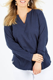 Model Jess wearing size 14 of the Fundamental Coles Bay Henley in colour Navy (Blue), from the front, cropped image