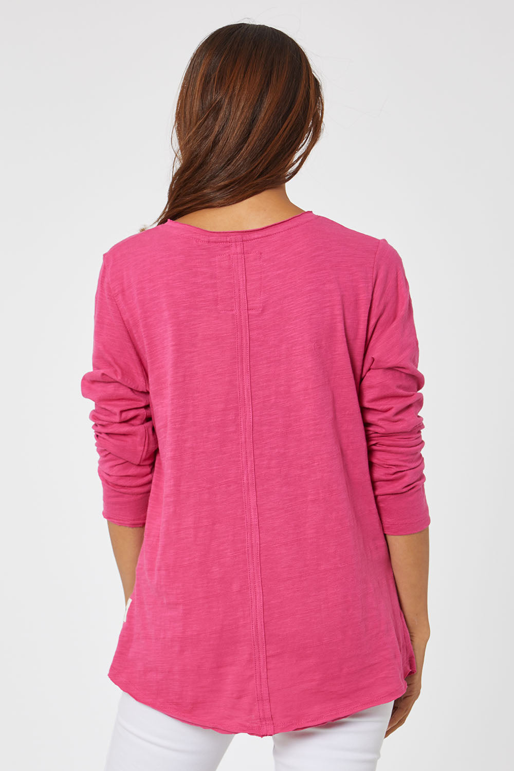 Model Cara wearing size 10 of the Fundamental Coles Bay Henley in colour Raspberry (Pink), from the back