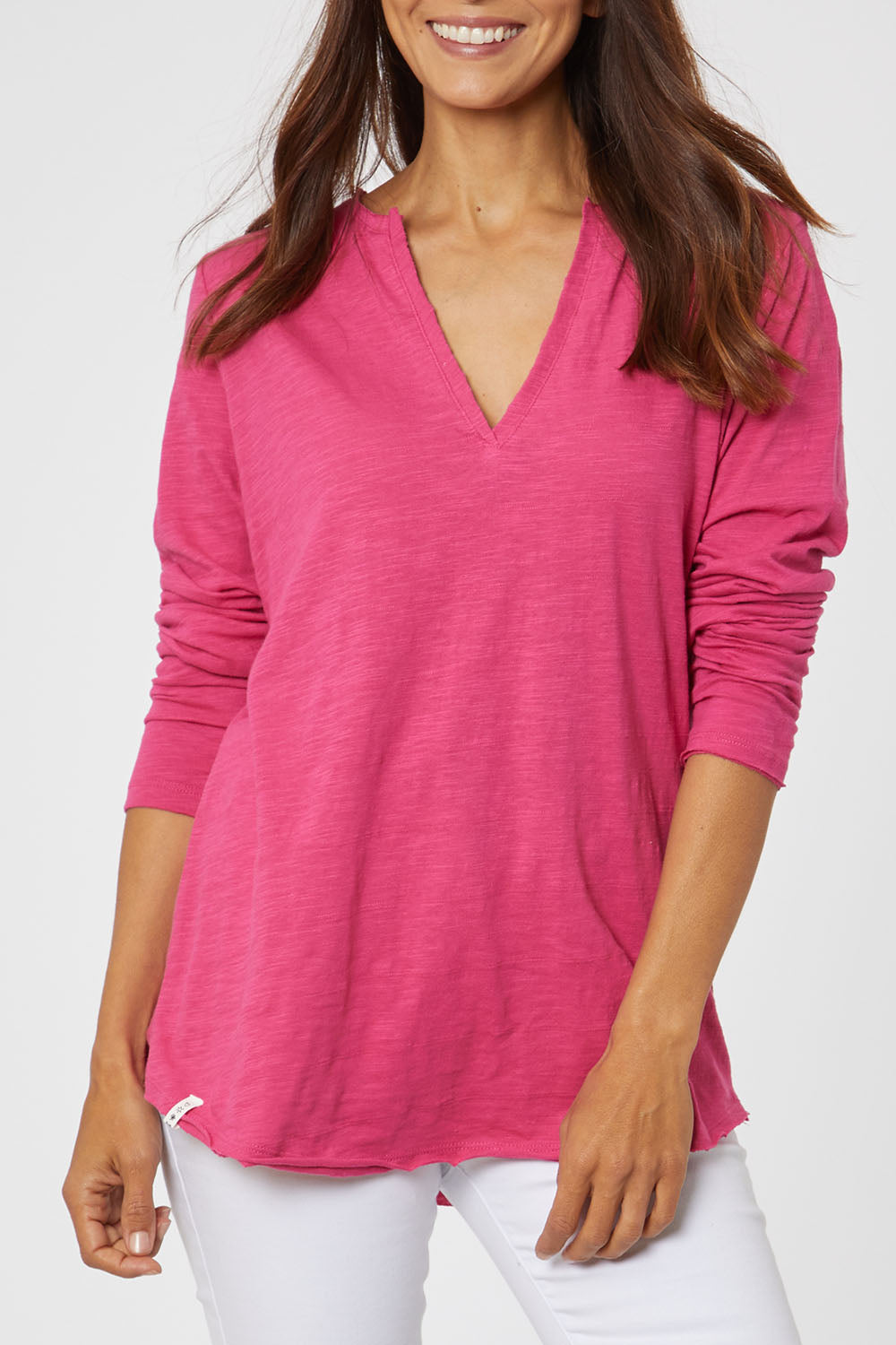 Model Cara wearing size 10 of the Fundamental Coles Bay Henley in colour Raspberry (Pink), from the front, cropped image