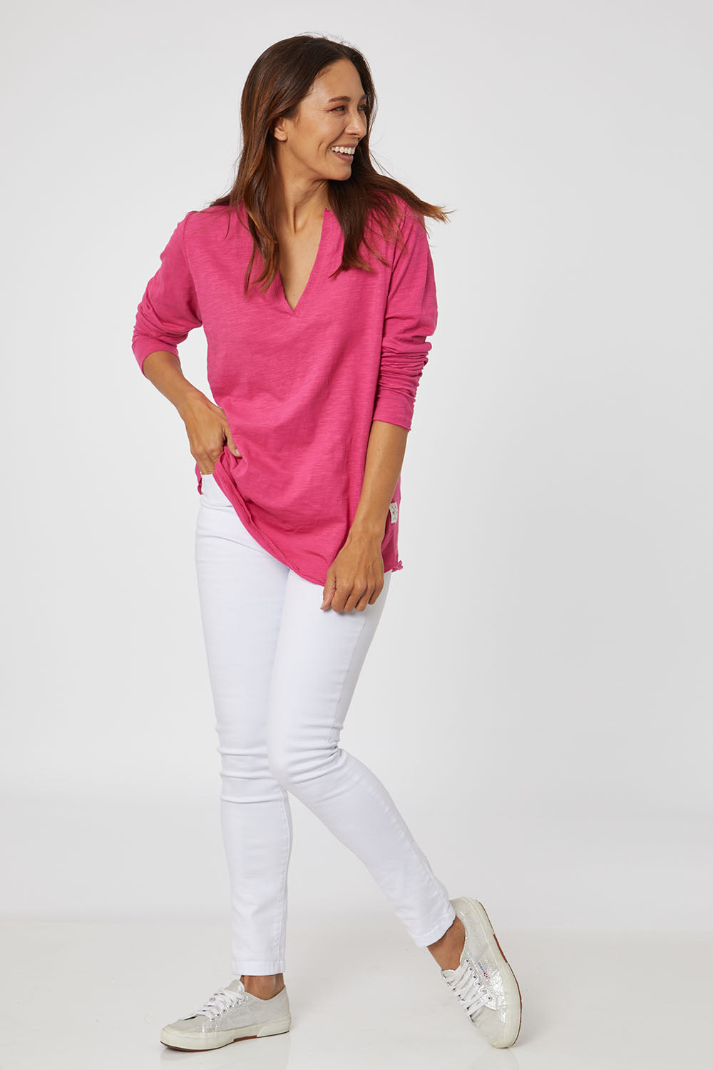 Model Cara wearing size 10 of the Fundamental Coles Bay Henley in colour Raspberry (Pink), from the front, showing the whole outfit