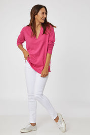 Model Cara wearing size 10 of the Fundamental Coles Bay Henley in colour Raspberry (Pink), from the front, showing the whole outfit